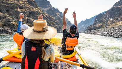 Rafters throwing their hands up while rafting Idaho's Lower Salmon River
