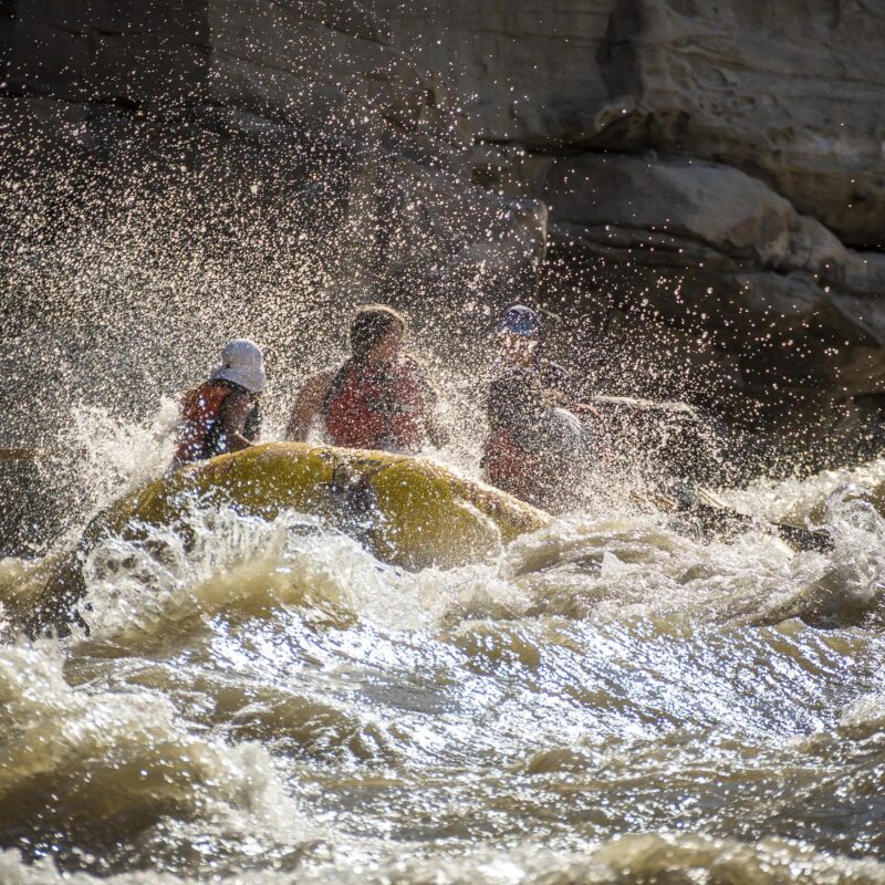 A raft splashes through a rapid on the Green River through Desolation Canyon
