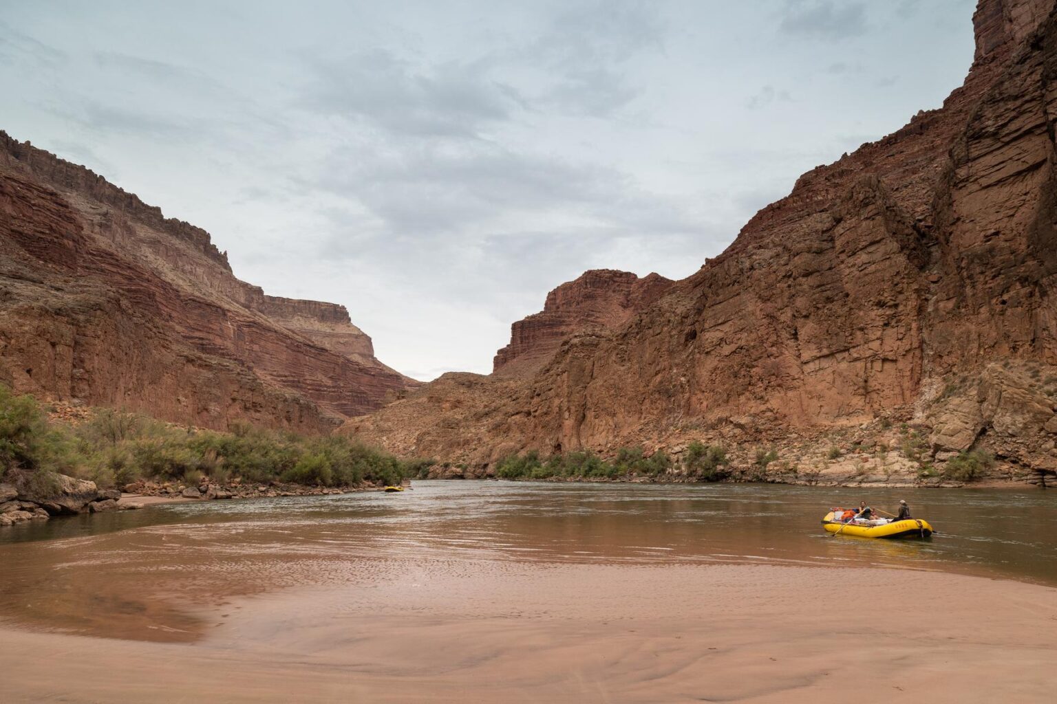 A river guide navigates low flows on the Colorado River on a Grand Canyon rafting trip