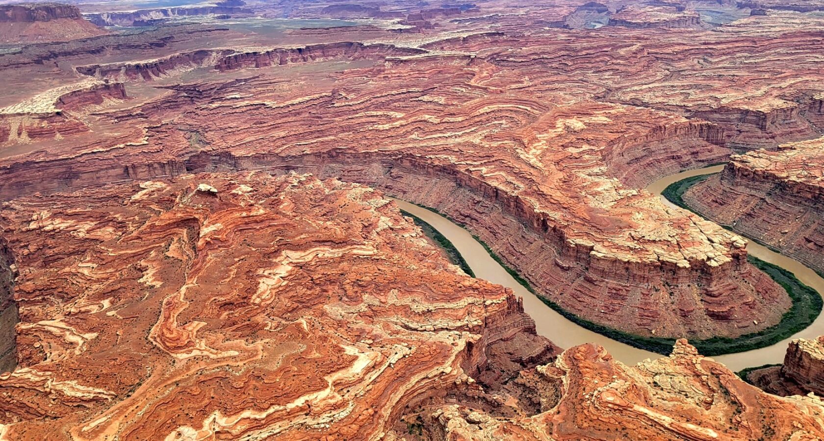 Ariel view of the Colorado River winding through a vibrant sandstone canyon