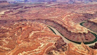 Ariel view of the Colorado River winding through a vibrant sandstone canyon