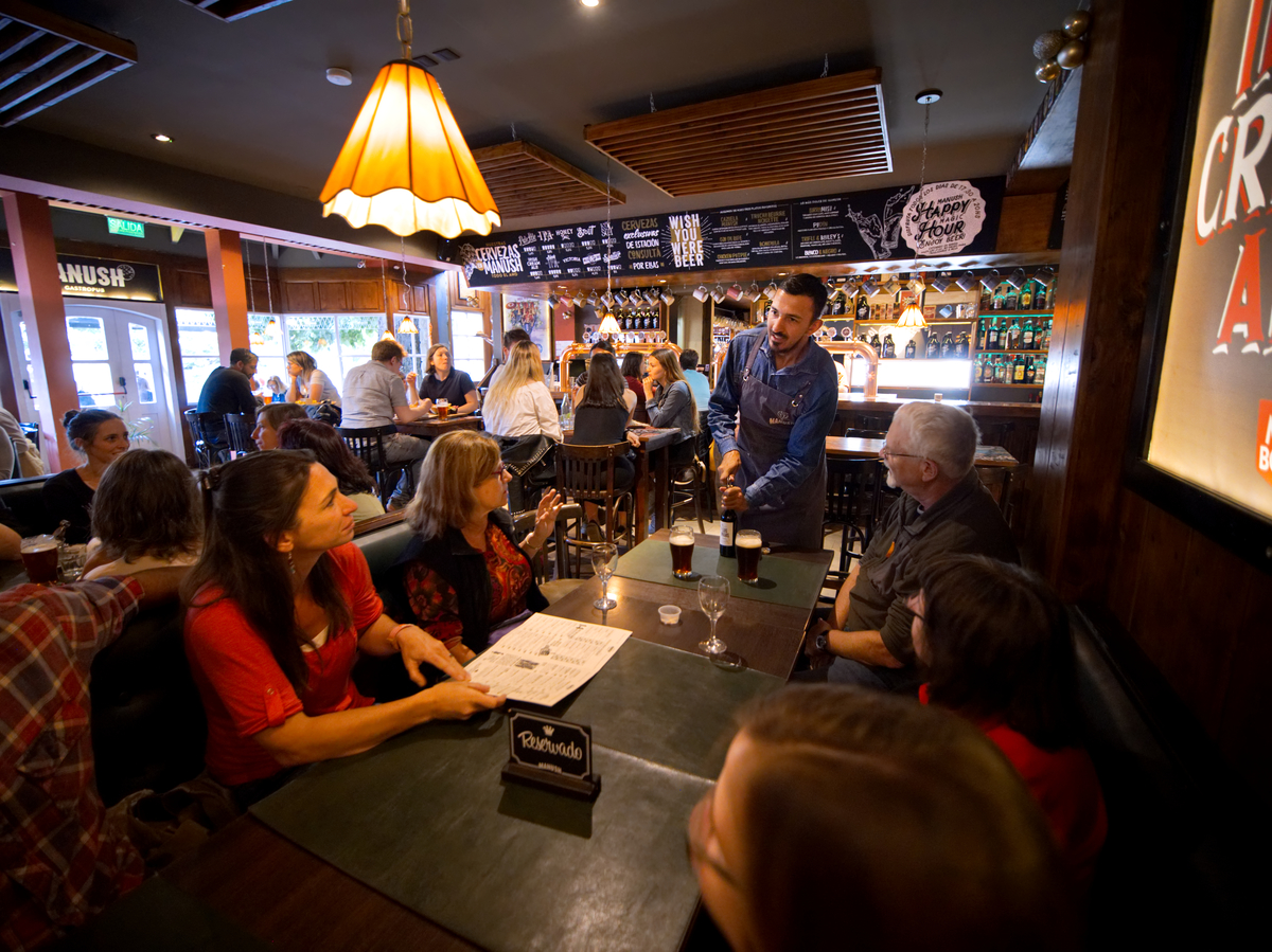 A group enjoys happy hour at a Patagonian pub