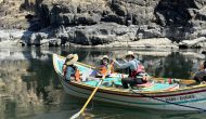 An OARS guide rows a dory on the Salmon River