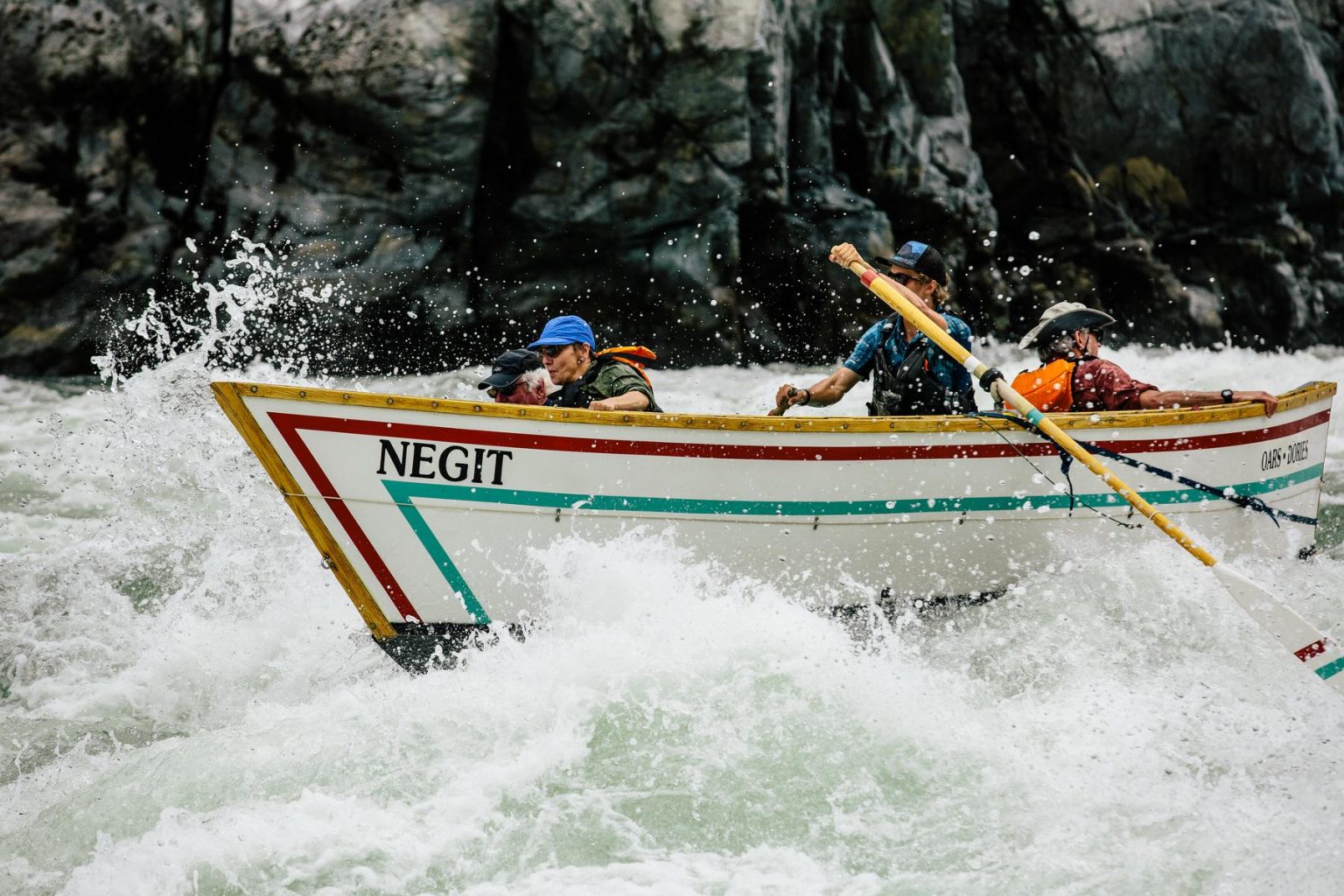 A dory navigates the Snake River through Hells Canyon