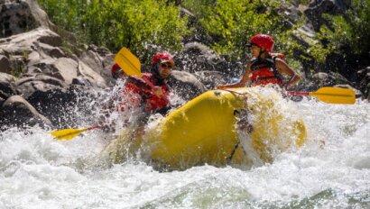 A raft with OARS guide school participants splashes through a rapid on the South Fork of the American River