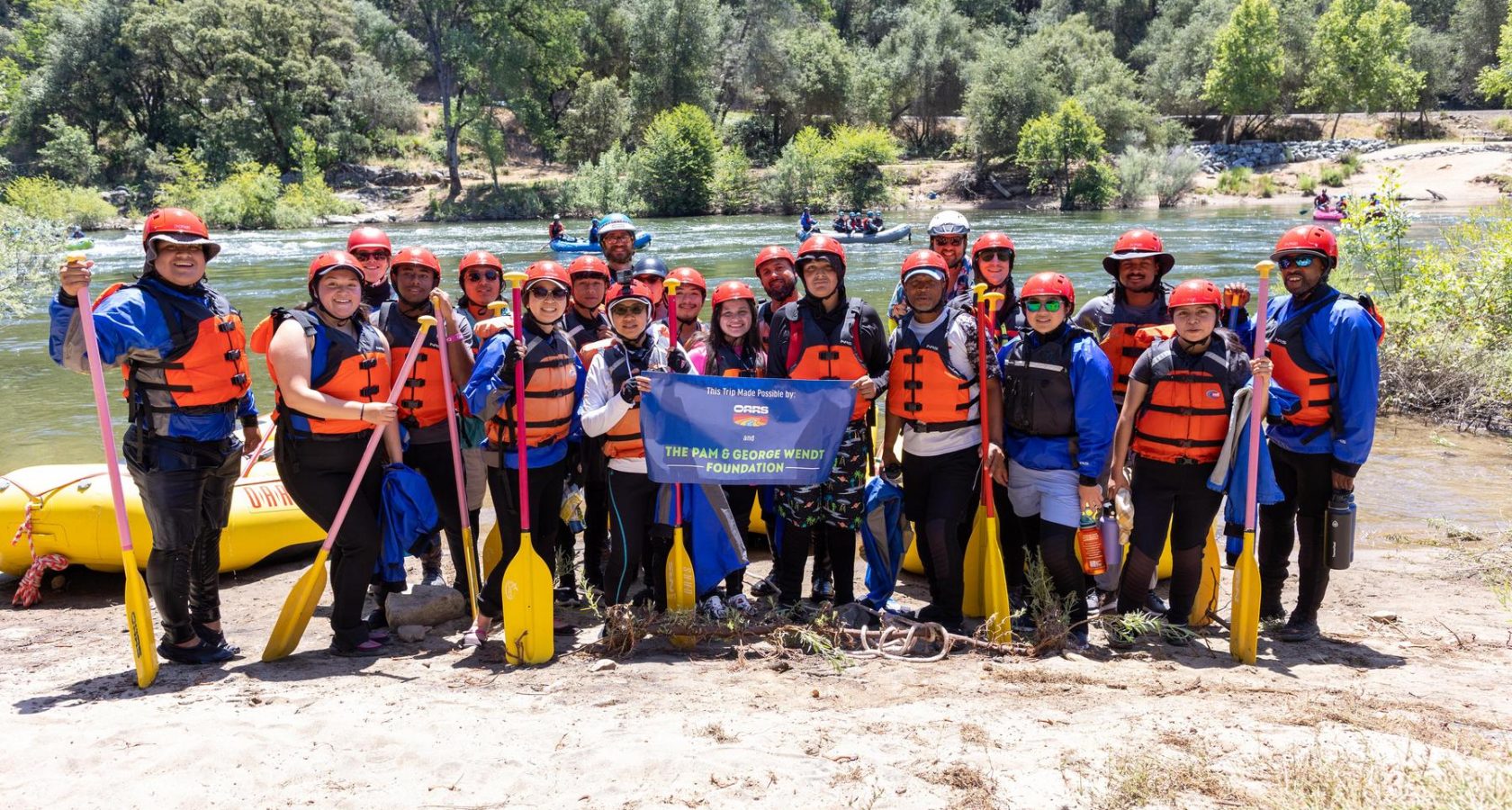 A group of rafting guests and OARS guides stand ready for a rafting trip on the South Fork of the American River