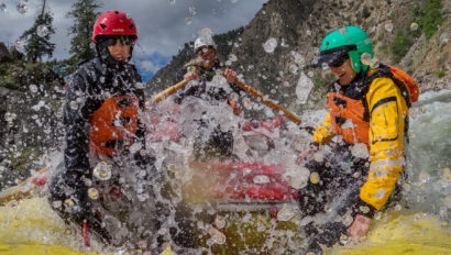 A pair of OARS guests gets splashed on the Middle Fork Salmon River rafting trip.