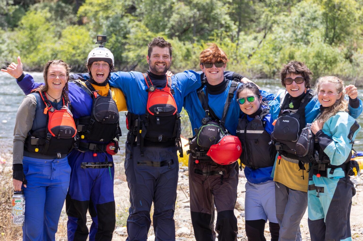 A group of OARS guides standing on the bank of the South Fork American River
