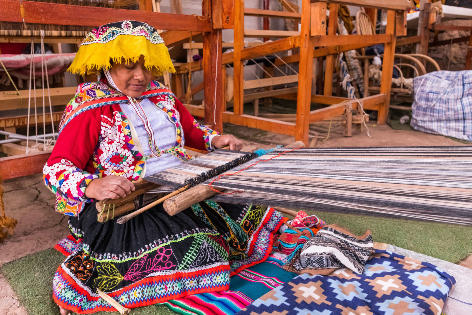 A Peruvian woman weaving a traditional cloth
