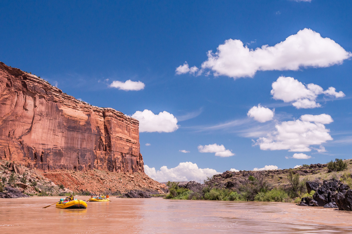 Rafting in Westwater Canyon under blue skies and white clouds