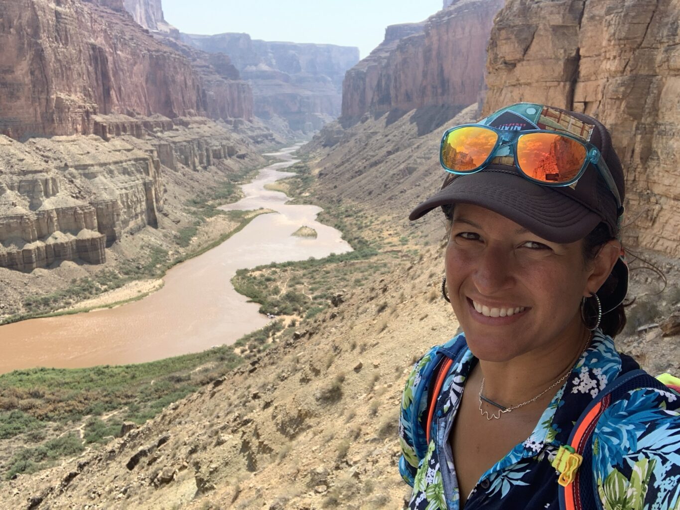 Dr. Melissa Giovanni in front of the Colorado River through Grand Canyon.