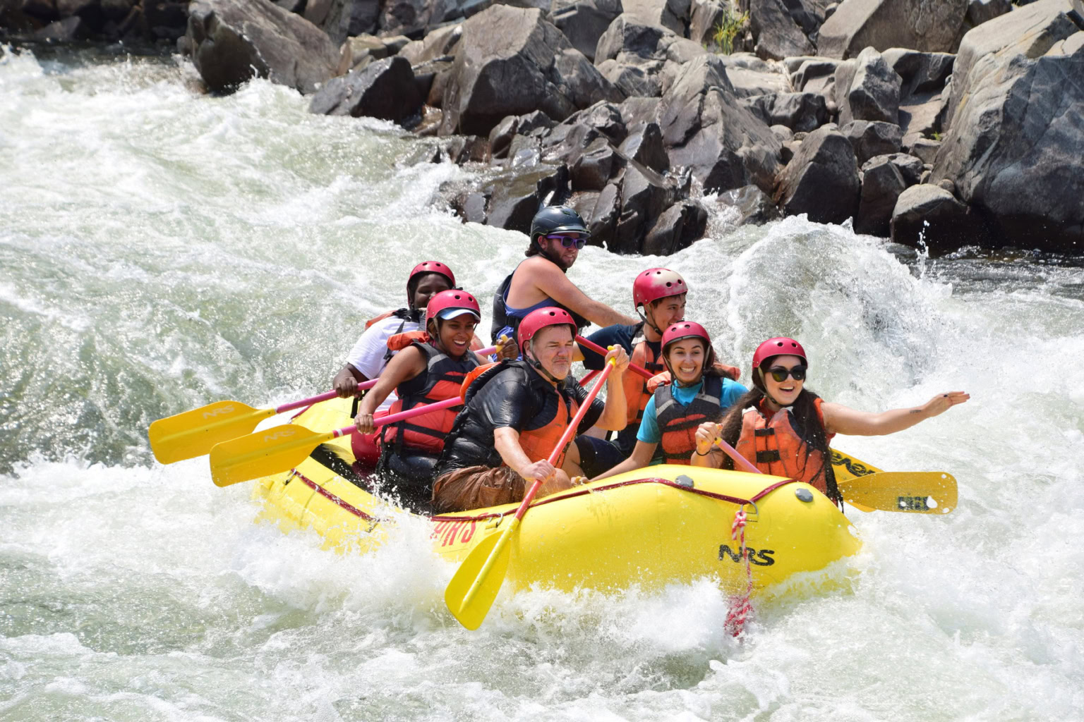A group splashes through rapids on the South Fork American River