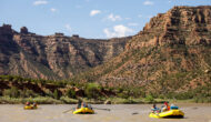 Three yellow rafts float down the Green River in Desolation Canyon, Utah.