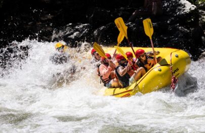 A yellow raft full of paddlers goes through a rapid on the South Fork American River.