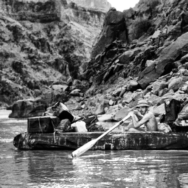 Early black and white photo of George Wendt at the oars in Grand Canyon