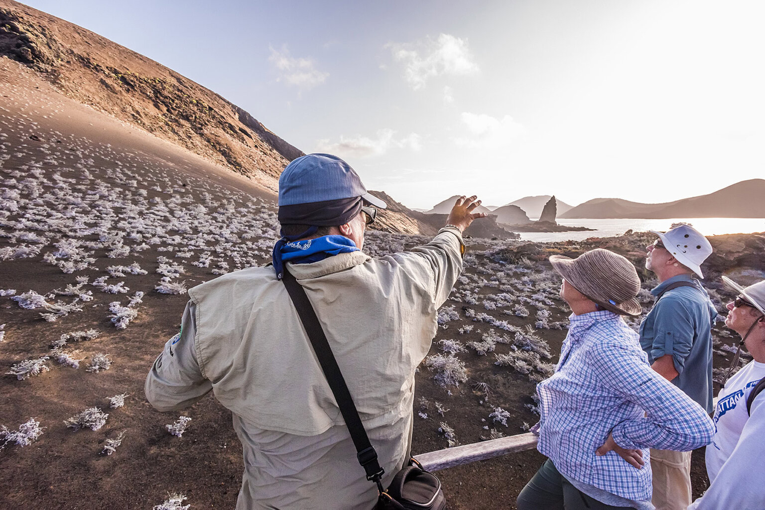 Guide points to the pinnacle rock at Bartolome Island Galapagos