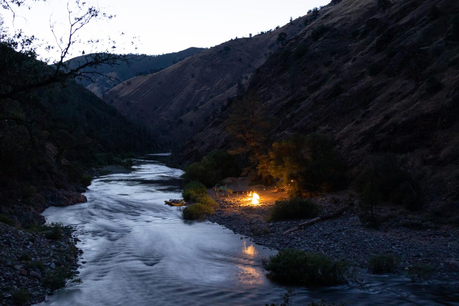 Tents lit up in a camp along the Tuolumne River near Yosemite