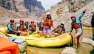 A group of women posing on a raft in Grand Canyon