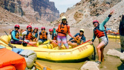 A group of women posing on a raft in Grand Canyon