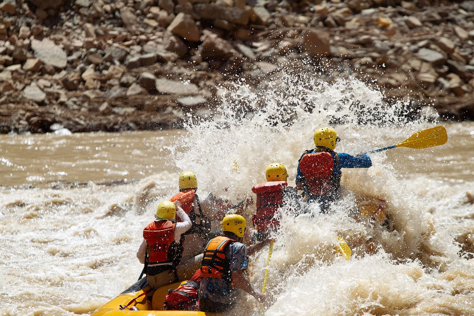 A group of paddler's crashes through a wave in Big Drop 2 Rapid on the Colorado River.