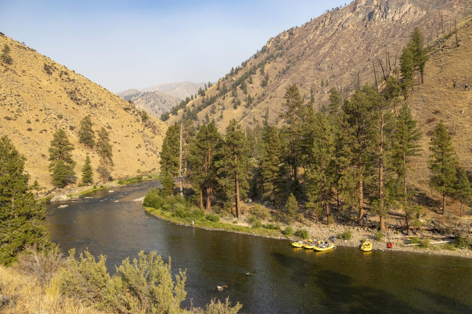 Late afternoon glow illuminating a scenic river canyon deep in Idaho's wilderness