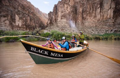 Guests in a dory engage in a water gun fight on the Colorado River in Grand Canyon