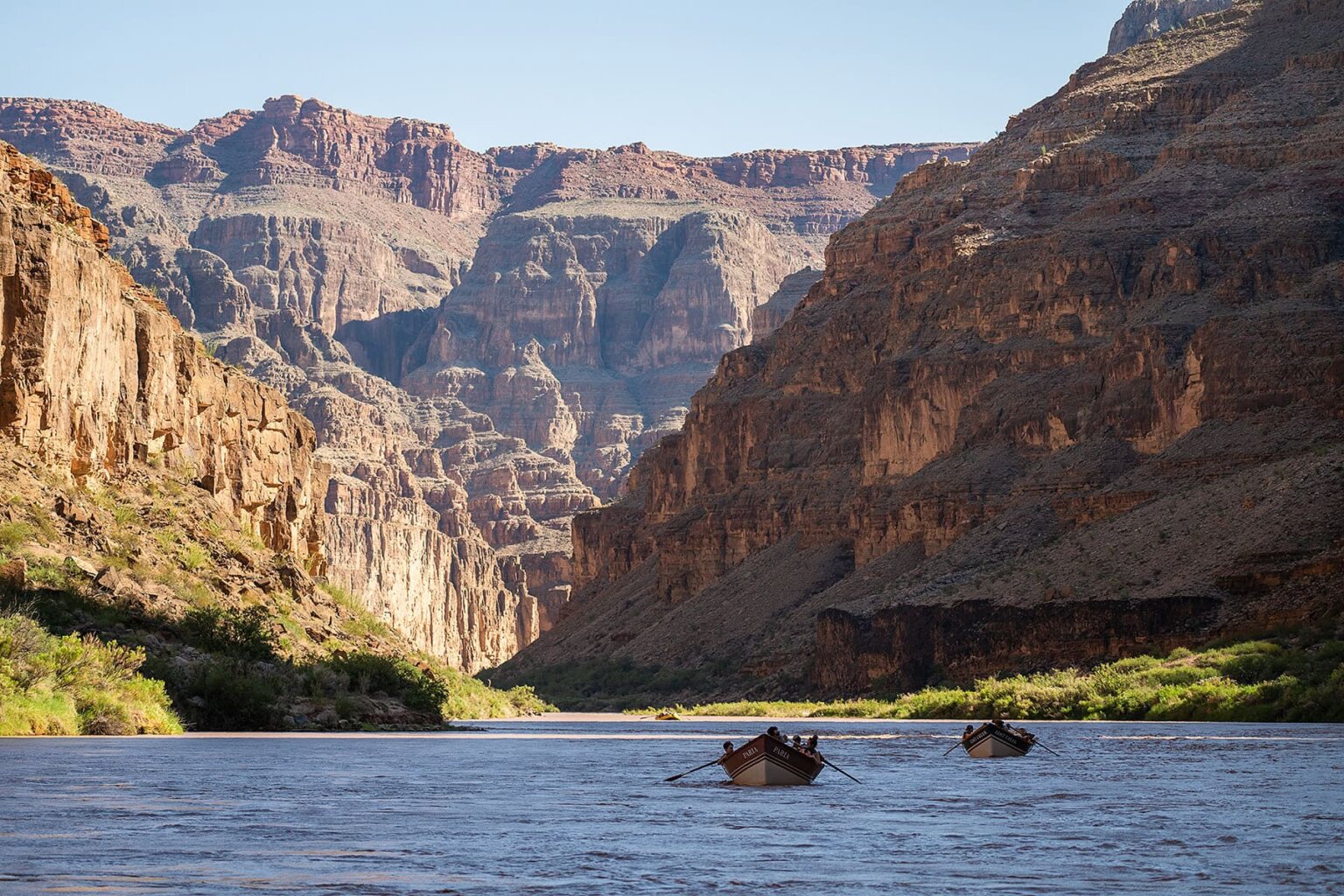 Dories row down the Colorado River in Grand Canyon