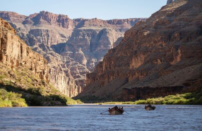 Dories row down the Colorado River in Grand Canyon