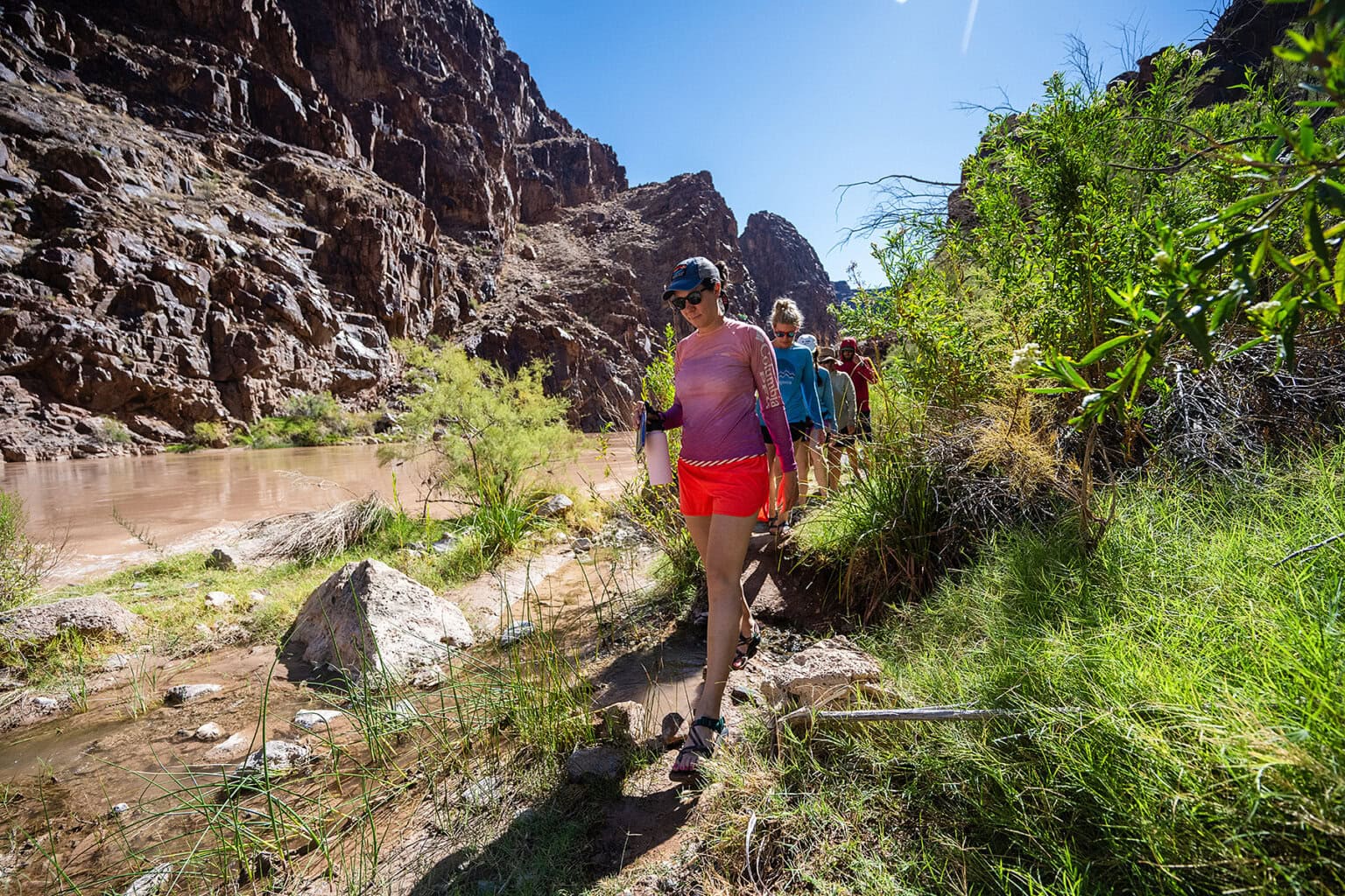 Guests hike along a trail in Grand Canyon