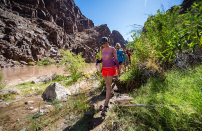 Guests hike along a trail in Grand Canyon