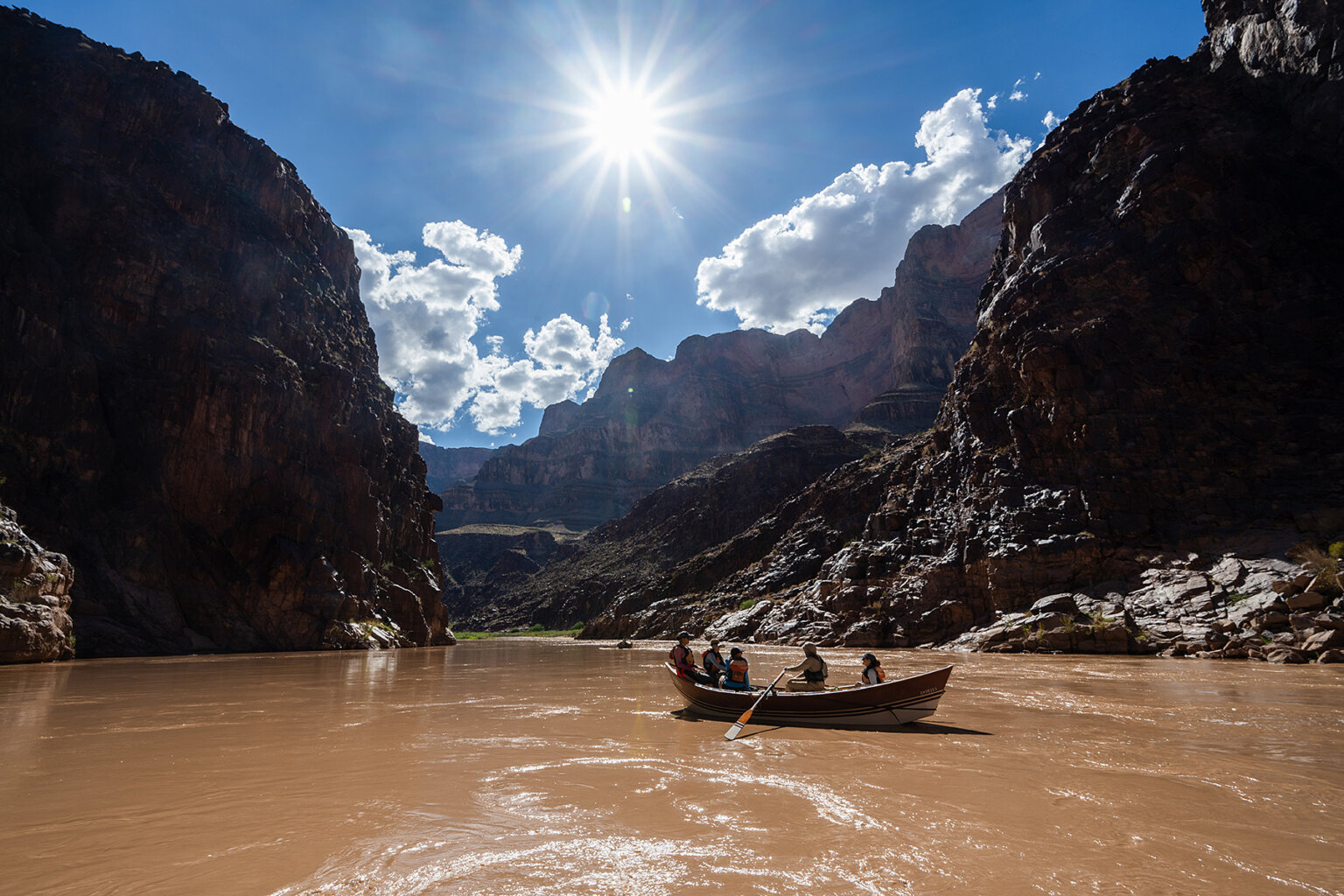 A dory floats down the Colorado River in Grand Canyon