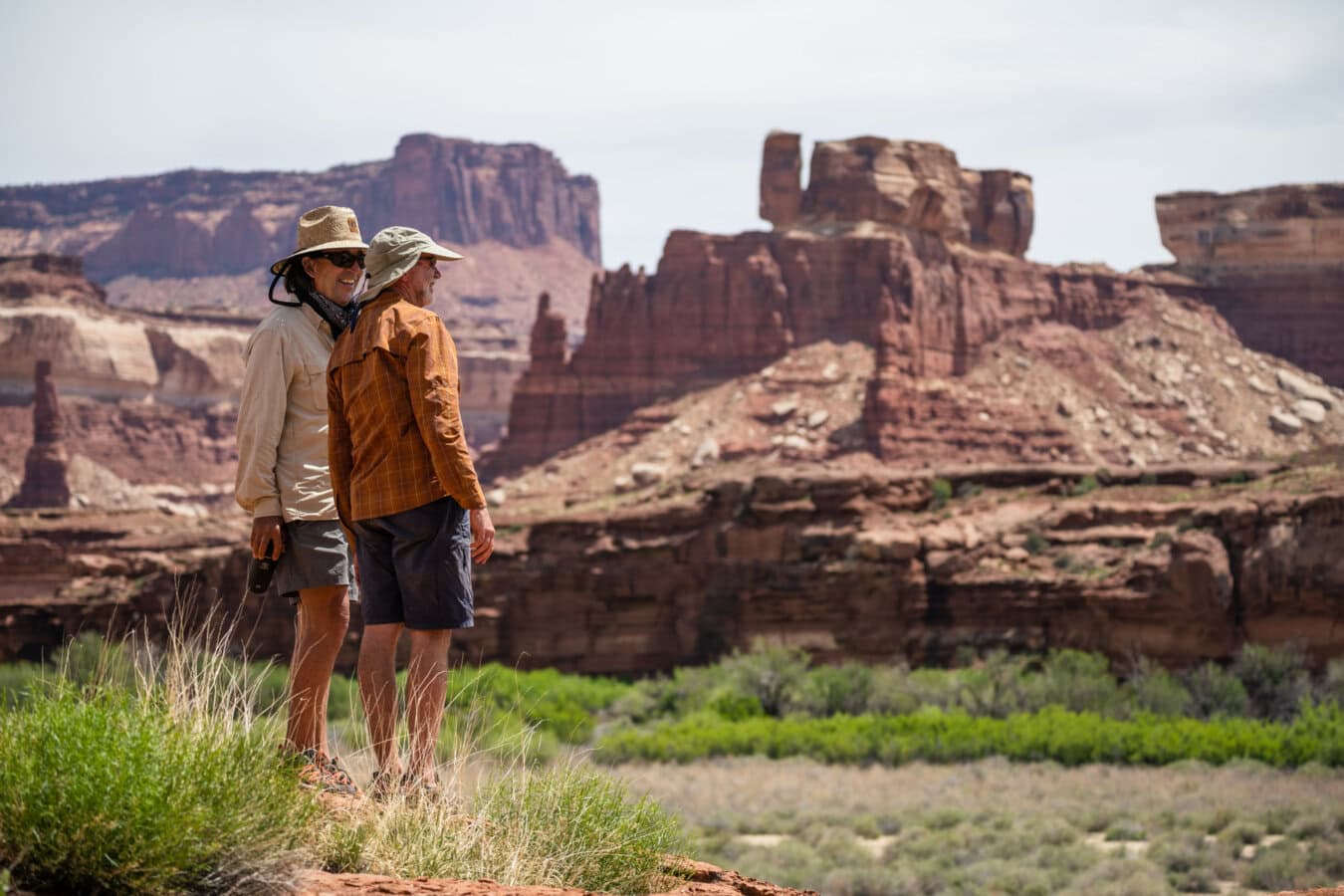 Two men stand overlooking a vista on a side hike in Canyonlands National Park