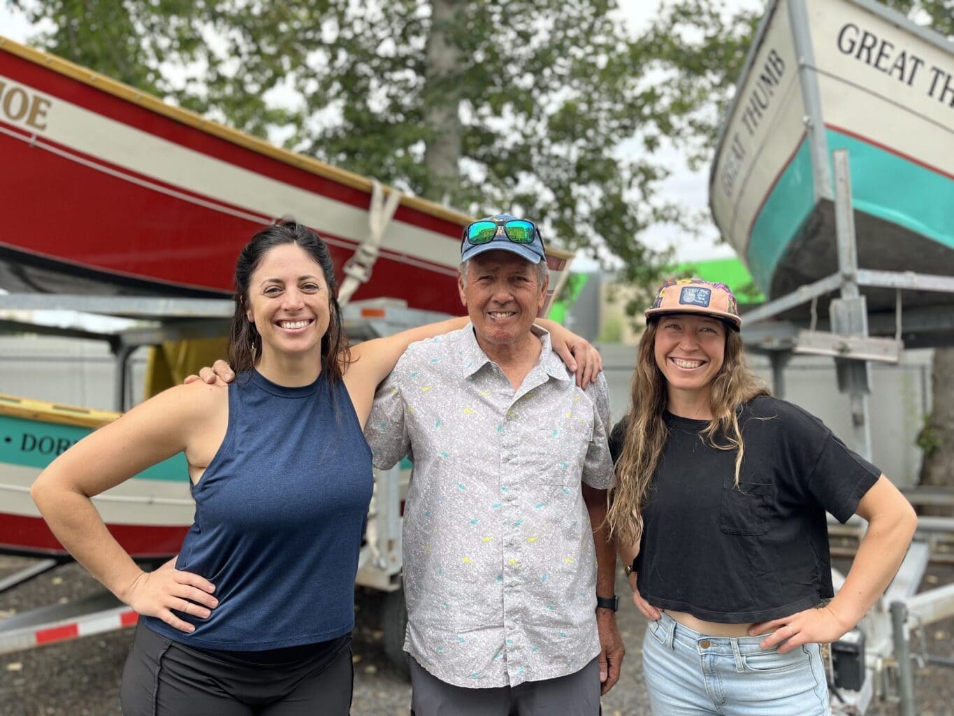 Hillary Mosman and Laren McCullough standing with their mentor and long-time OARS Dories manager, Curt Chang.