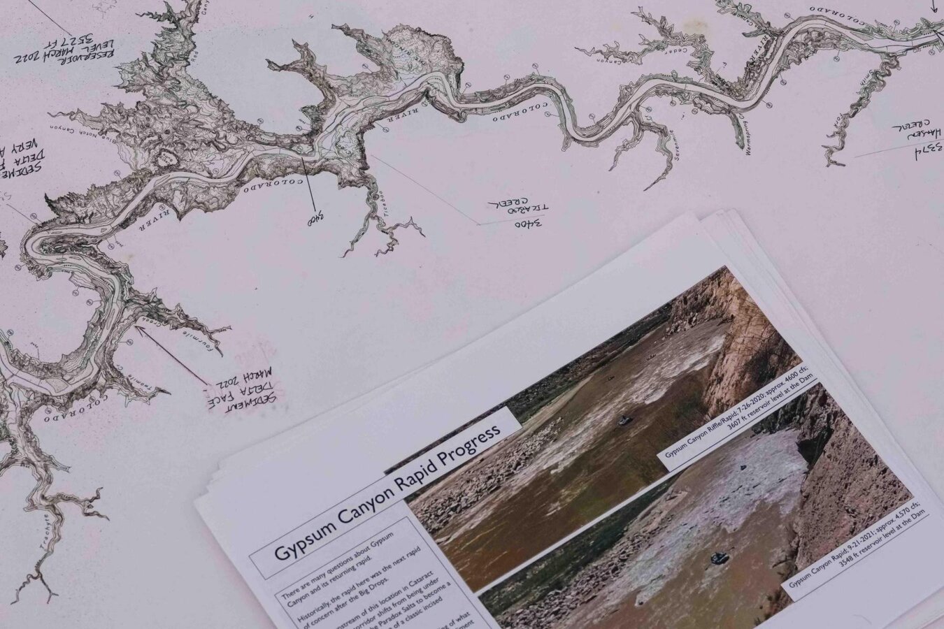 A map of the Colorado River and research materials by the Returning Rapids Project
