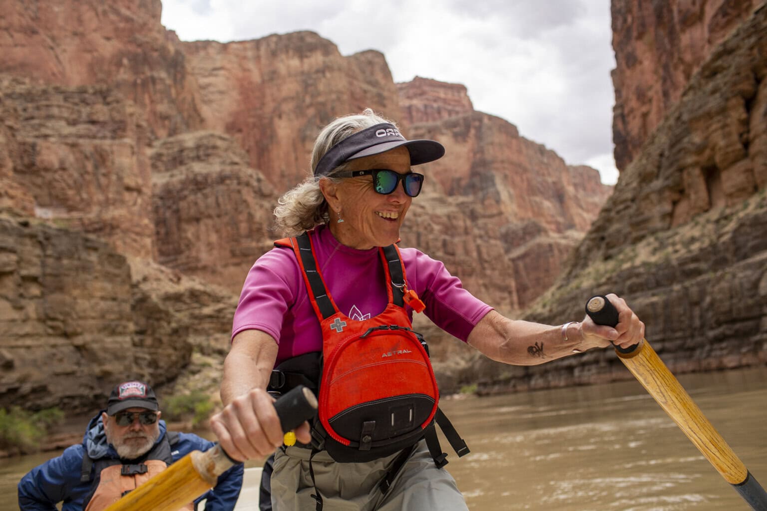 Cindell Dale, a legendary woman dory guide, rows a guest on a scenic stretch of the Grand Canyon