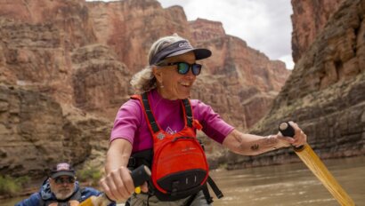 Cindell Dale smiles as she rows a dory in Grand Canyon.