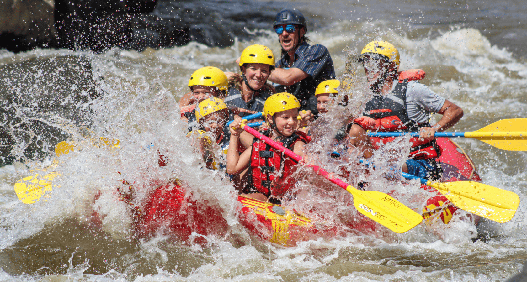 A group of rafters splashes through a rapid on the Rio Grande River in New Mexico.