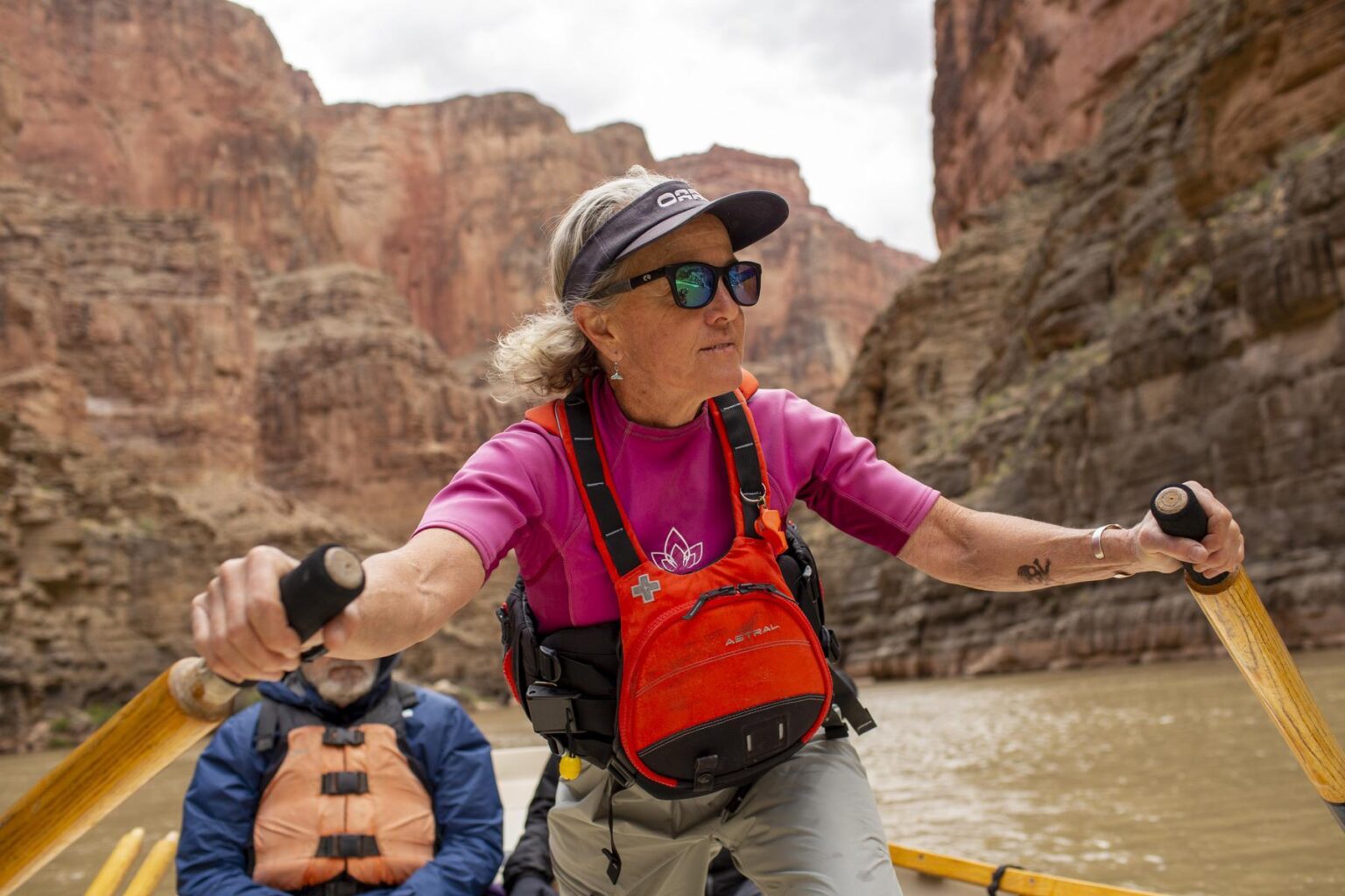 A river guide named Cindell Dale rows a dory through Grand Canyon.