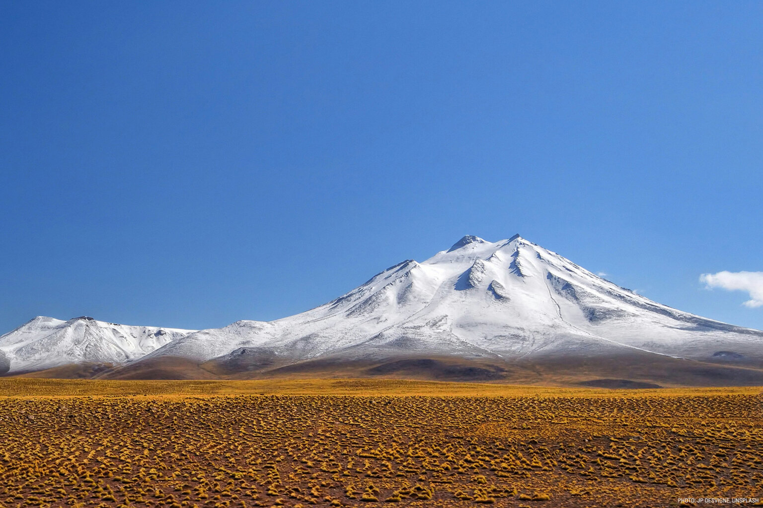 A photo of Chile's high desert and a snowy mountain peak