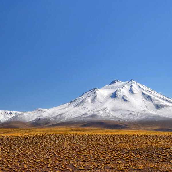 A photo of Chile's high desert and a snowy mountain peak