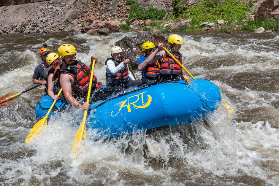 A group of rafters splash through whitewater in the Royal Gorge Canyon.
