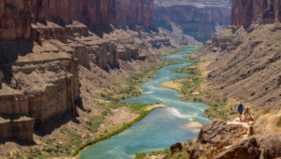A blue-green Colorado River winds it way through Grand Canyon