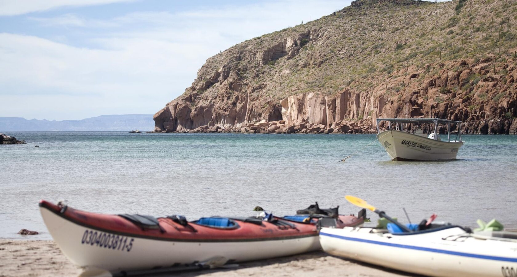 Kayaks rest on a beach on an island in the Sea of Cortez