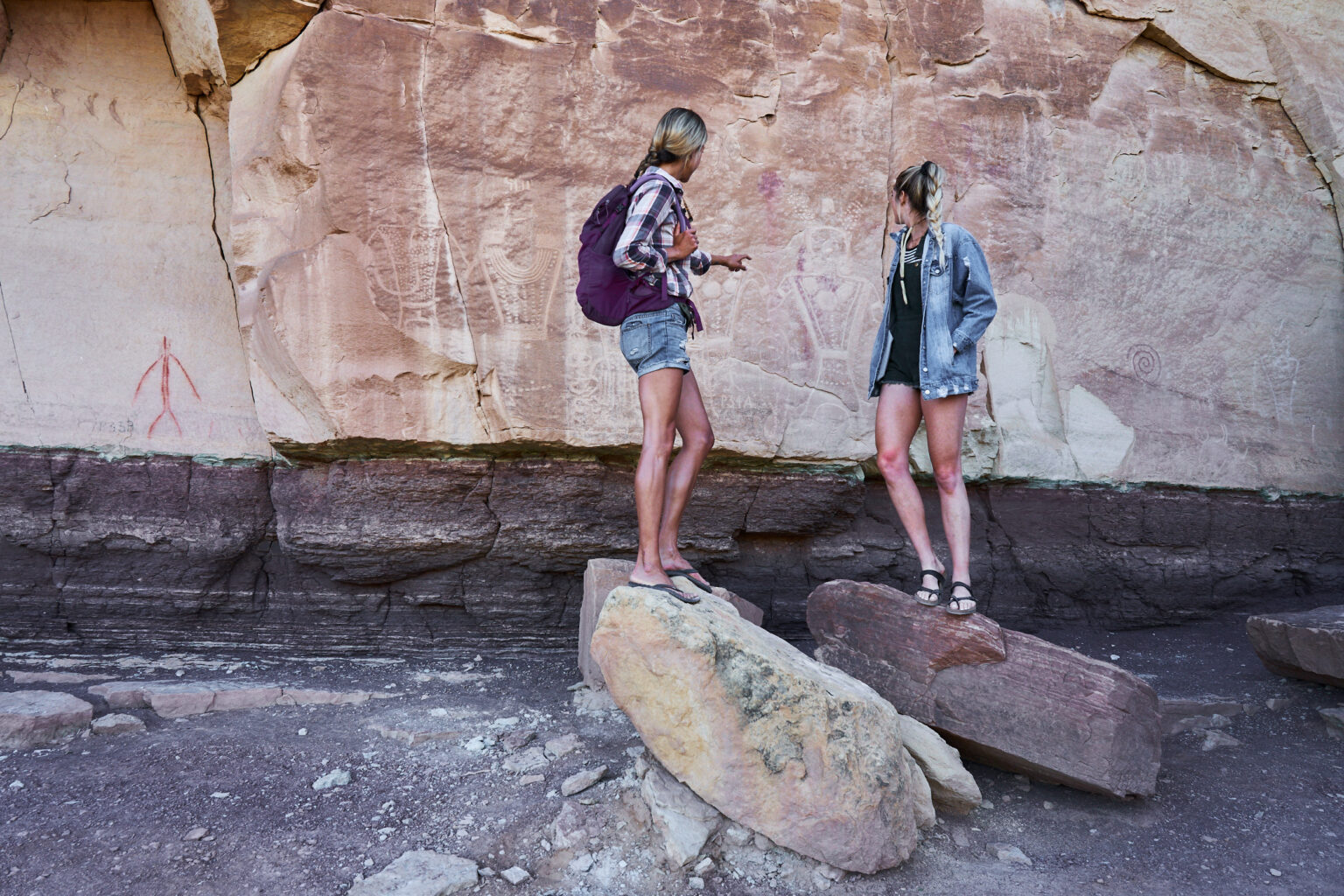 Two women standing in front of the McConkie Ranch Main Panel of Classic Vernal Style Fremont rock imagery.