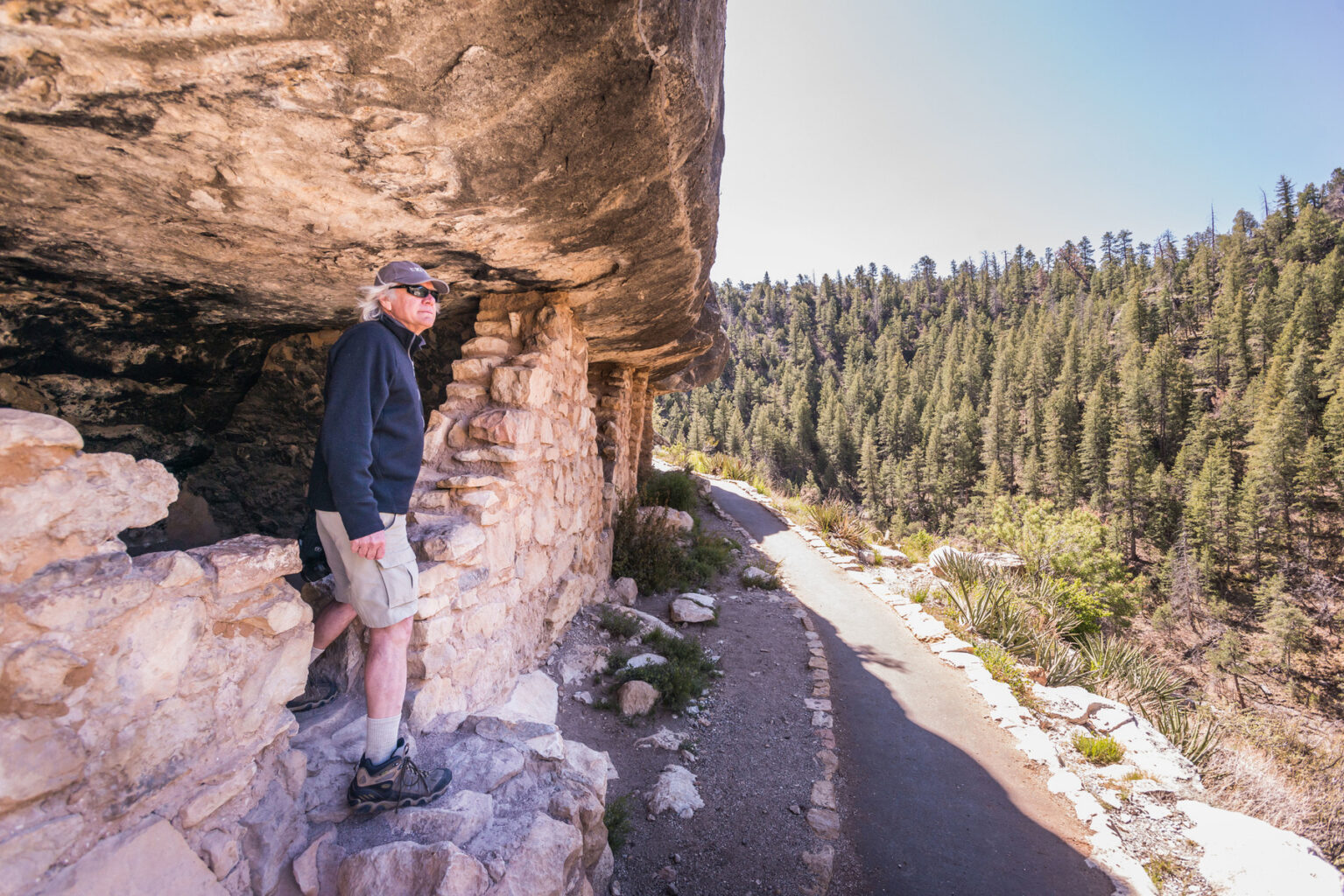 A man explores a cliff dwelling at Walnut Canyon National Monument near Flagstaff, AZ.