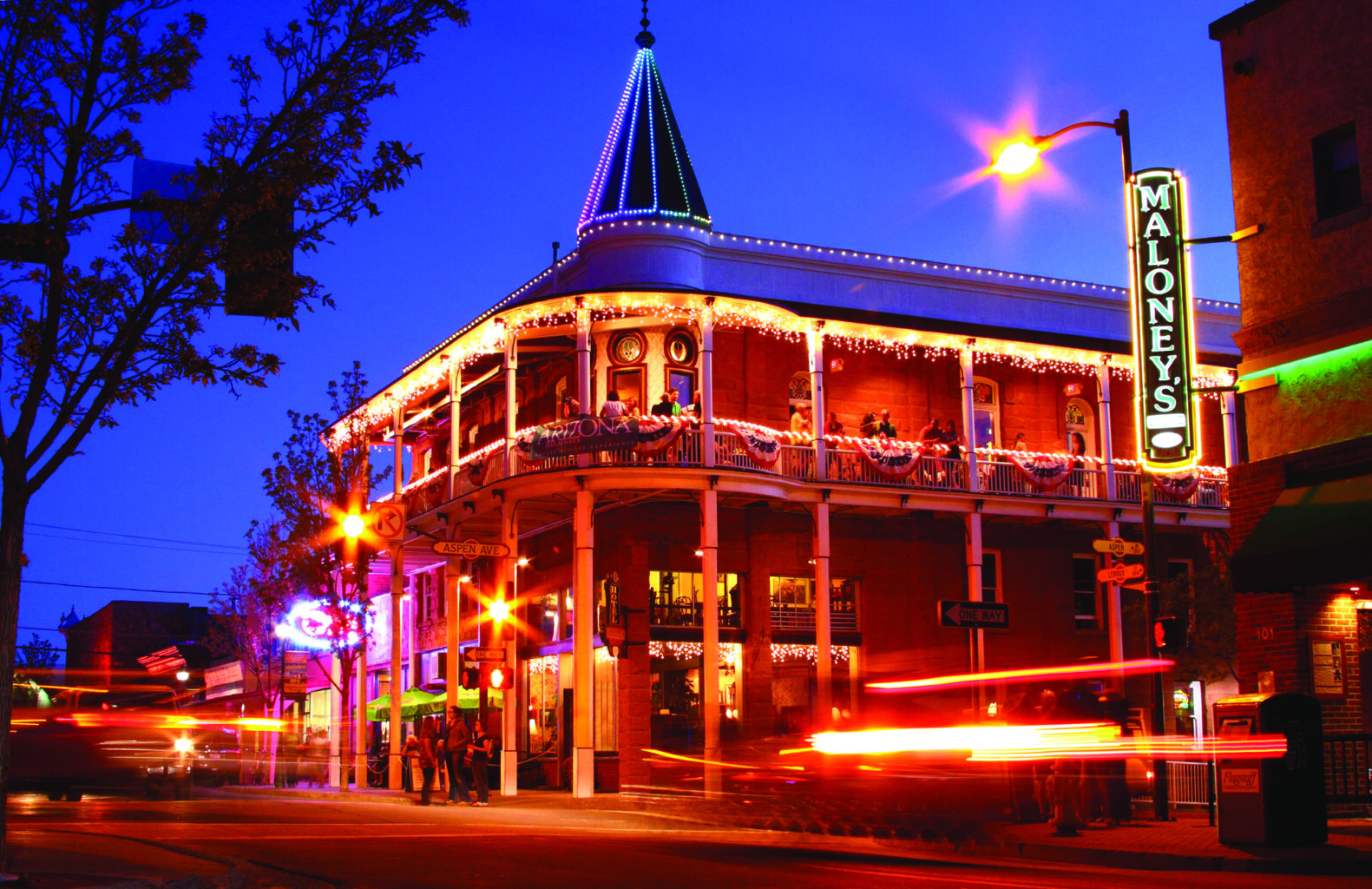 The upstairs balcony at the Weatherford Hotel offers a lively night scene.