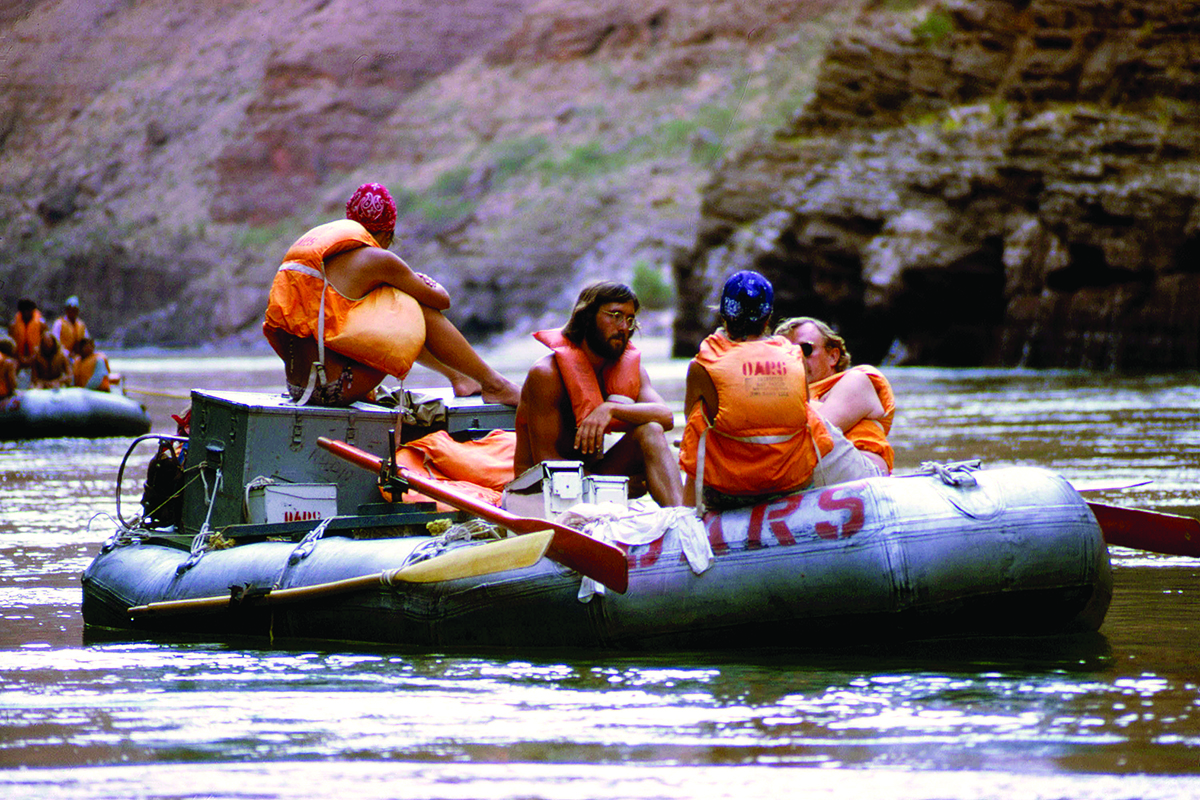 Skip Horner rowing an OARS raft in Grand Canyon, 1974